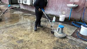employees use a concrete floor scrubber