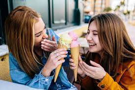A Couple of Friends Share Their Strawberry and Vanilla Ice Creams Outdoors  Stock Photo - Image of girlfriend, girls: 176064562