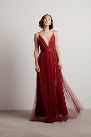 Fitted waist tops a full maxi skirt with a daring side slit. Burgundy Dresses Maroon Dress Long Wine Colored Dress Tobi