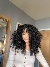 Parting curly or wavy bangs in the center opens up your forehead ever so slightly without foregoing texture. Curtain Bangs But Make Em Curly Curly Hair With Bangs Curly Hair Styles Curly Hair Latina