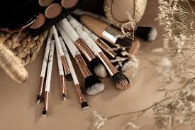 makeup brushes with eyeshadows on beige