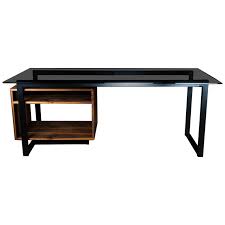A black metal frame supports the desk with two legs and a crossbar on one side and a set of drawers on the other. Hamilton Modern Desk By Ambrozia Tinted Glass Black Steel Solid Black Walnut For Sale At 1stdibs