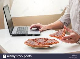 Stressed Out Business Man Holding A Slice Of Pizza Having A