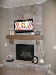 stone corner fireplace with tv above