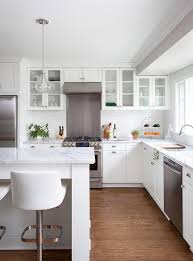 white kitchen with gl front cabinets