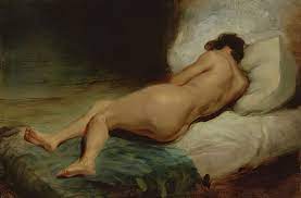 Nackte Frau liegt auf einem Bett