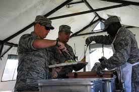reservists prepare and serve meal in a