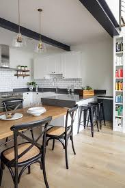 white kitchen with black ceiling beams