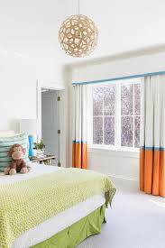 boys room with orange banded curtains