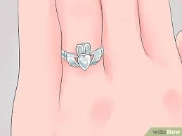 To wear a claddagh ring if youre dating someone put it on the ring finger of your right hand with the heart pointing toward the center of your hand. 3 Ways To Wear A Claddagh Ring Wikihow