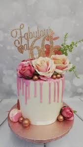 pink drip cake with artificial flowers