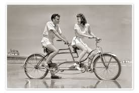 young couple riding a tandem bike on