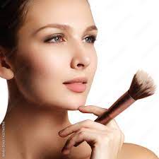 beauty model with makeup brush bright