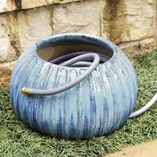 The unique shape offers space for a coiled hose, and the cutout provides easy access to your existing water spigot. 17 Garden Hose Storage Solutions Hgtv