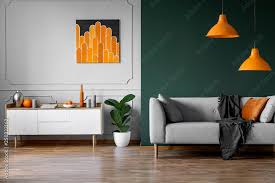 abstract orange painting on grey wall