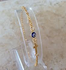 tiny gold evil eye cross bracelet
