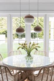 beige wicker chairs at round glass top