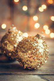 Golden christmas ornaments on rustic ...