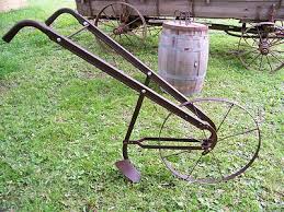 antique steel wheeled garden push plow