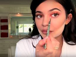 kylie jenner applies lip liner with her