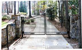Brick driveways enhance the look of the houses where they are installed. Automated Gate System With Stone Walls And Columns Woodstock Apex Fence Company
