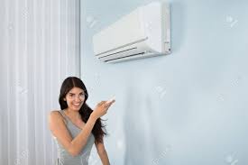 Young Happy Woman Holding Remote Control Air Conditioner In House Stock  Photo, Picture And Royalty Free Image. Image 39658128.